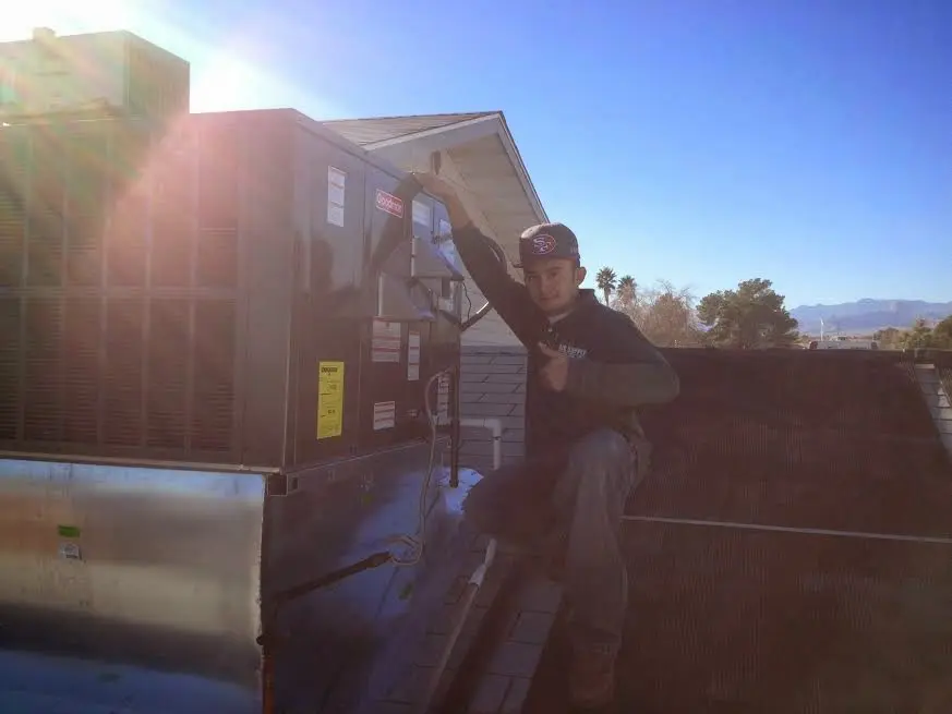 HVAC technician performing HVAC Inspection on a rooftop unit in Wickenburg